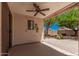 Covered patio provides comfortable outdoor space with views of the landscaped backyard at 40329 W Thornberry Ln, Maricopa, AZ 85138