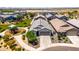 Aerial view of the home showcasing landscaping, tile roof, two-car garage, and neighborhood park at 4114 S 106Th Dr, Tolleson, AZ 85353