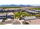 Aerial view of a modern community showcasing green spaces, well-kept lawns, and residential homes against a mountain backdrop at 4114 S 106Th Dr, Tolleson, AZ 85353
