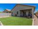 Backyard with covered patio and well-maintained artificial grass at 4114 S 106Th Dr, Tolleson, AZ 85353