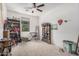Bedroom with bookshelves, keyboard, and natural light from a window at 4114 S 106Th Dr, Tolleson, AZ 85353