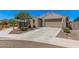 Well-maintained house with desert landscaping and a spacious driveway at 4114 S 106Th Dr, Tolleson, AZ 85353