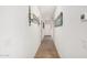 Inviting hallway featuring elegant light fixtures and decorative wall art at 4114 S 106Th Dr, Tolleson, AZ 85353