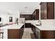 Spacious kitchen with stainless steel appliances, large white countertops and dark brown cabinetry at 4114 S 106Th Dr, Tolleson, AZ 85353