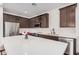 Charming kitchen with stainless steel appliances, white countertops and dark brown cabinetry at 4114 S 106Th Dr, Tolleson, AZ 85353