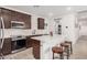 Charming kitchen featuring stainless steel appliances, white countertops, dark brown cabinetry, and pantry at 4114 S 106Th Dr, Tolleson, AZ 85353