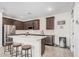 Charming kitchen with stainless steel appliances, white countertops and dark brown cabinetry with adjacent wine fridge at 4114 S 106Th Dr, Tolleson, AZ 85353