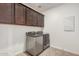 Laundry room includes cabinetry above the side-by-side washer and dryer at 4114 S 106Th Dr, Tolleson, AZ 85353