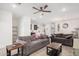 Comfortable living room with modern ceiling fan and view into the adjacent kitchen at 4114 S 106Th Dr, Tolleson, AZ 85353