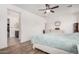Bright main bedroom with white furniture, ceiling fan and ensuite bathroom at 4114 S 106Th Dr, Tolleson, AZ 85353