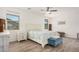 Bright main bedroom with white furniture, ceiling fan and blue accents at 4114 S 106Th Dr, Tolleson, AZ 85353