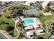 Aerial view of community pool, tennis courts, playground, and park with mature trees at 4306 E Raven Rd, Phoenix, AZ 85044