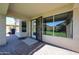 Covered patio with brick pavers leads to a large window viewing the green, landscaped yard at 4306 E Raven Rd, Phoenix, AZ 85044