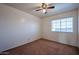 Clean, empty bedroom featuring a window and carpeted floor ready to be personalized at 4306 E Raven Rd, Phoenix, AZ 85044