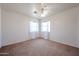 Spacious bedroom with carpeted floor, complemented by white curtains and abundant natural light at 4306 E Raven Rd, Phoenix, AZ 85044