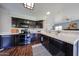 Well-equipped kitchen with dark wood cabinetry, modern appliances, and tile countertops at 4306 E Raven Rd, Phoenix, AZ 85044