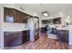 Spacious kitchen with stainless steel appliances, dark wood cabinets and hardwood floors at 4306 E Raven Rd, Phoenix, AZ 85044