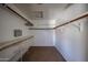 Spacious walk-in closet features custom shelving and rod for optimal storage solutions at 4306 E Raven Rd, Phoenix, AZ 85044