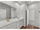 Bathroom featuring double sinks, wood-look flooring, and well-lit mirrors at 5881 N 193Rd Dr, Litchfield Park, AZ 85340