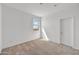 Cozy bedroom with neutral carpet, white walls, a window, and closet door at 5881 N 193Rd Dr, Litchfield Park, AZ 85340