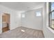 Bright bedroom featuring neutral carpet, two windows and an ensuite bathroom at 5881 N 193Rd Dr, Litchfield Park, AZ 85340