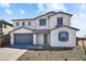 Charming two-story home featuring a gray two-car garage and well-maintained landscaping at 5881 N 193Rd Dr, Litchfield Park, AZ 85340