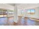Spacious living room with light-colored walls, wood floors, and bright natural light at 5881 N 193Rd Dr, Litchfield Park, AZ 85340