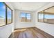 Bright, airy living room featuring wood floors, large windows and neutral walls at 5881 N 193Rd Dr, Litchfield Park, AZ 85340