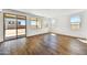 Bright, airy living room featuring wood floors, large windows and glass sliding doors at 5881 N 193Rd Dr, Litchfield Park, AZ 85340