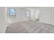 Bright main bedroom featuring neutral carpet, two windows and an ensuite bathroom at 5881 N 193Rd Dr, Litchfield Park, AZ 85340