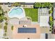 Aerial view of the backyard with a kidney-shaped pool, artificial turf, a covered patio, and solar panels at 625 E Silver Creek Rd, Gilbert, AZ 85296