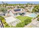 Aerial view of backyard with a pool, patio, artificial turf, concrete pad, and solar panels at 625 E Silver Creek Rd, Gilbert, AZ 85296