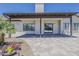 Back patio featuring brick pavers, large windows, and a manicured landscape at 625 E Silver Creek Rd, Gilbert, AZ 85296