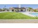 Well-maintained backyard featuring a pool, artificial grass, and covered patio at 625 E Silver Creek Rd, Gilbert, AZ 85296