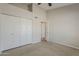 Carpeted bedroom with ceiling fan, closet and neutral color scheme creates a comfortable and versatile space at 625 E Silver Creek Rd, Gilbert, AZ 85296