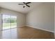 Bedroom with a sliding glass door that provides access to the lush backyard and an artificial lawn at 625 E Silver Creek Rd, Gilbert, AZ 85296