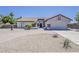 Front view of home with low desert landscaping, tile roof, brick accents, and a two-car garage at 625 E Silver Creek Rd, Gilbert, AZ 85296