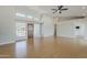 Open floor plan with a light filled living room featuring wood floors, a ceiling fan, and high ceilings at 625 E Silver Creek Rd, Gilbert, AZ 85296