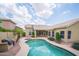 Aerial view of a lush backyard oasis, featuring a private pool and mature landscaping with a desert backdrop at 6388 W Donald Dr, Glendale, AZ 85310