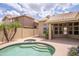Serene backyard features a pool, spa, and covered patio, creating an ideal space for relaxation at 6388 W Donald Dr, Glendale, AZ 85310