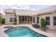 Inviting backyard showcasing a private pool, desert landscaping, and an adjacent covered patio for outdoor relaxation at 6388 W Donald Dr, Glendale, AZ 85310