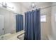 Cozy bathroom featuring a vanity with mirror, toilet, and bathtub with blue shower curtain at 6388 W Donald Dr, Glendale, AZ 85310