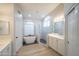 Bright bathroom with white cabinets, glass shower, and stand alone tub at 6388 W Donald Dr, Glendale, AZ 85310