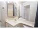 Bathroom vanity with a bright light and mirror with open door at 6388 W Donald Dr, Glendale, AZ 85310