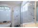 Bright bathroom featuring a frameless glass shower and stand alone tub at 6388 W Donald Dr, Glendale, AZ 85310