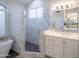 Bright bathroom featuring white cabinets, a glass shower, and a modern tub at 6388 W Donald Dr, Glendale, AZ 85310