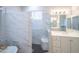 Bright bathroom with a glass shower, white tile, and vanity at 6388 W Donald Dr, Glendale, AZ 85310