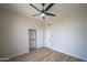 Clean bedroom with fan, closet and bright natural light, featuring wood-look flooring at 6388 W Donald Dr, Glendale, AZ 85310
