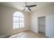 Inviting bedroom with a large window, closet, light colored walls and wood-look floors at 6388 W Donald Dr, Glendale, AZ 85310