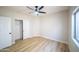 Bright bedroom features wood-look flooring, ceiling fan, a closet, and two doors for easy access at 6388 W Donald Dr, Glendale, AZ 85310